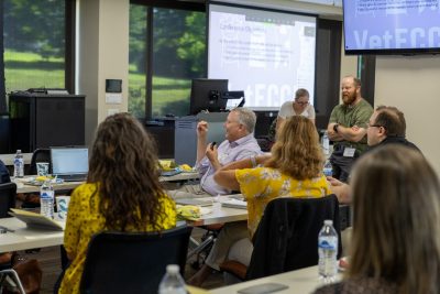 Classroom of veterinary professionals discussing emergency veterinary medicine.
